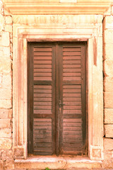 Fototapeta na wymiar Old brown wooden door on stone wall