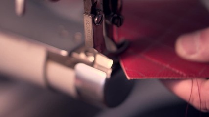Milan, Italia, July 15, 2019: Red leather on the table. Tools of ardigano that tones the skin. thickness gauge, scissors, leather cutting knives, ruler and skochka on the table. Working process - Powered by Adobe