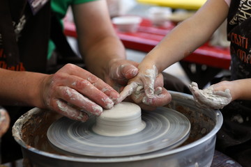 Master of ceramics. We work with clay. The master ceramist teaches the student. Craftsman hands sculpts clay