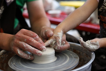 Master of ceramics. We work with clay. The master ceramist teaches the student. Craftsman hands sculpts clay