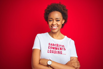 African american woman wearing sarcastic comments t-shirt over red isolated background happy face smiling with crossed arms looking at the camera. Positive person.