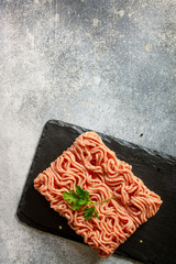 Fresh Raw mince. Ground Minced beef on stone slate blackboard. Top view flat lay.