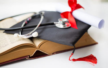 Black graduation cap, degree and stethoscope - obrazy, fototapety, plakaty