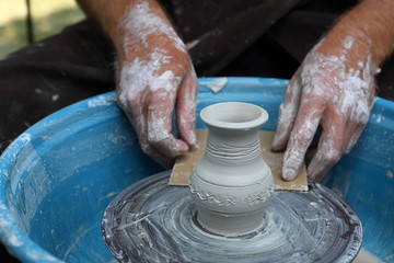 Master of ceramics. We work with clay. The master ceramist teaches the student. Craftsman hands sculpts clay