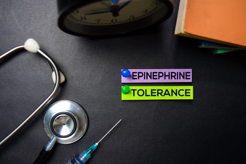 Epinephrine Tolerance text on Sticky Notes. Top view isolated on black background. Healthcare/Medical concept