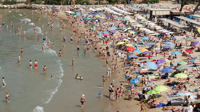 Time lapse in Capellans beach, Salou, Spain. Crowded beach at summer