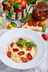 Spaghetti pasta with sun dried tomatoes and basil leaf. Vegetarian food. 