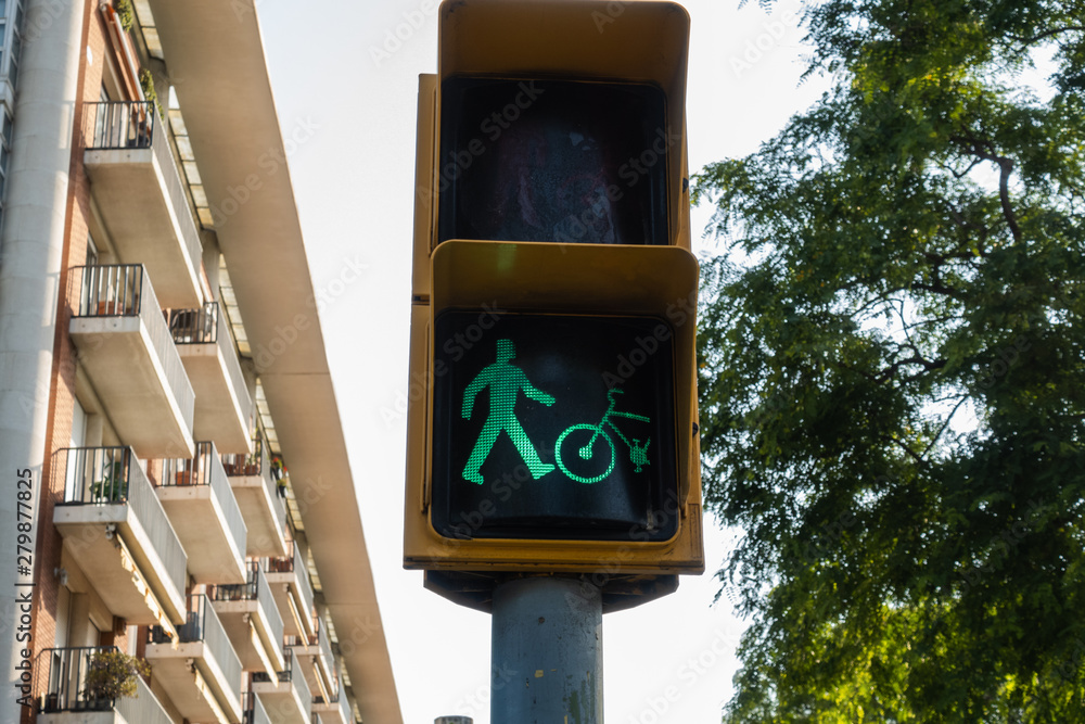 Wall mural traffic light lighting green for pedestrians and bikes