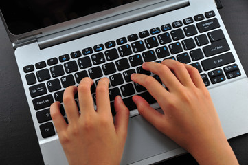 Close-up of typing female hands on keyboard