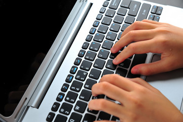 Close-up of typing female hands on keyboard