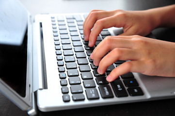 Close-up of typing female hands on keyboard