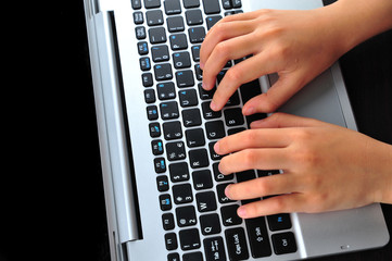 Close-up of typing female hands on keyboard
