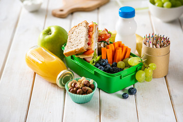 Back to school concept - lunch box with juice, apple and banana, copy space