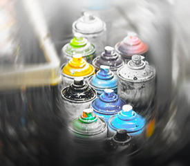 Bright stained paint cans belonging to a street artist. Graffiti and spray painting is a bold and...