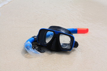 Swimming mask with snorkel in the sand