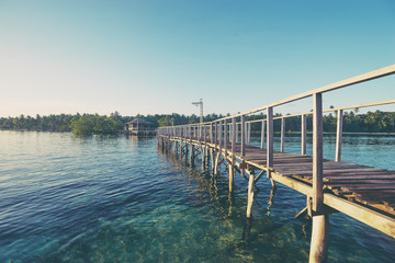Beautiful landscape. Sunset on the seashore. Wooden bridge on the beach, Siargao Island, Philippines.