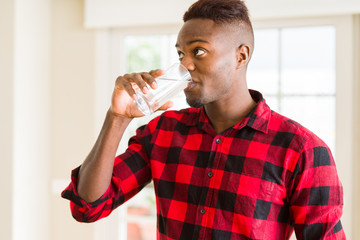 Young african american man drinking a fresh glass of water