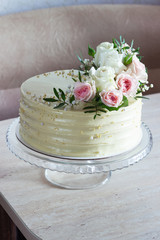 Beautiful Wedding cake with flowers on marble table and white background