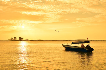 Fisherman boat with sunset background