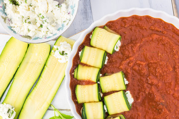 Zucchini rollups with cheese in marinara sauce.