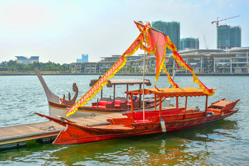 Tour boat at jetty on the Putrajaya Lake with blue skies