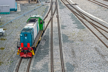 The grid of the railway, on the rocks, the train is moving on the tracks