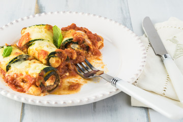 Zucchini rollups with cheese in marinara sauce.