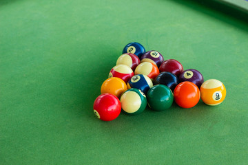billiard game balls on table with green synthetic smooth coating surface