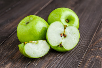 Ripe green apples and apple slices on old wooden background.Vegan and vegetarian concept.Concept for healthy eating and nutrition