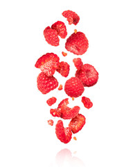 Whole and sliced raspberries in the air isolated on a white background