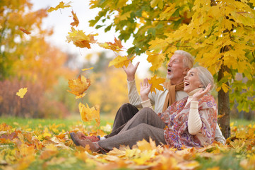 Happy senior woman and man in park