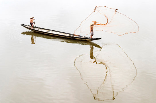 Men fishing in river, Vietnam