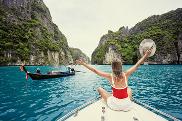 Traveling by Thailand. Pretty young woman enjoying view sailing on the yacht by Phi Leh lagoon. - obrazy, fototapety, plakaty