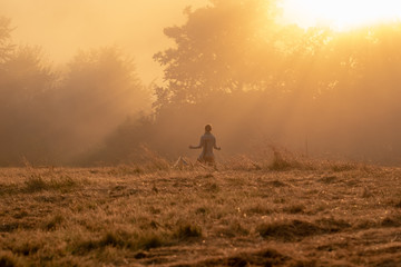 A couple practicing yoga at sunset in beautiful mountains_2