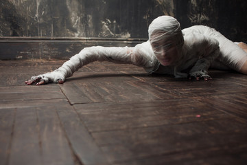 Scary mummy creeps on you. The girl with the bandage Crawling on the floor