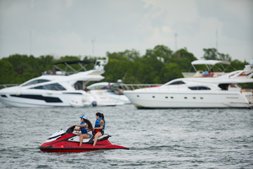 Young women riding a wave runner in Miami Beach