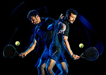 one caucasian Paddle tennis player man studio shot isolated on black background with light painting blur effect