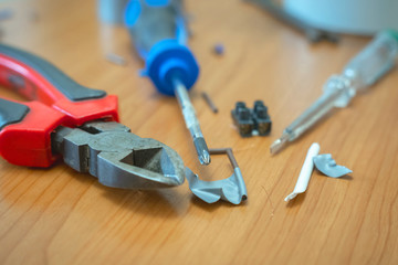 electrical tools lying on a table, close up, blurred background