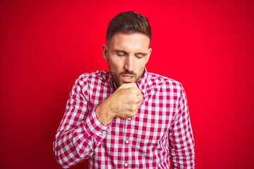 Fototapeta premium Young handsome man over red isolated background feeling unwell and coughing as symptom for cold or bronchitis. Healthcare concept.