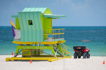 Green Miami Beach lifeguard tower with ocean view in background