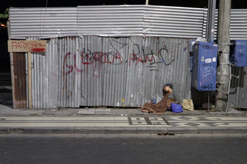 old woman and her child sleep on pedestian