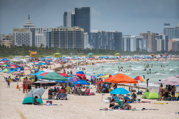 Tourists on Miami Beach. Getting ready for a day at the beach