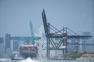 Fototapeta na wymiar Telephoto shot Port of Miami Florida with cargo ship loading