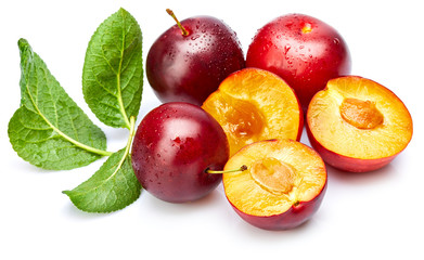 Fresh plum in cut with green leaf. Fruity still life. Healthy food. Isolated on white background.