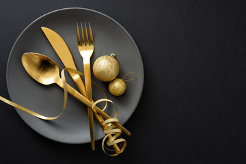 Gold cutlery served on plate for Christmas Dinner