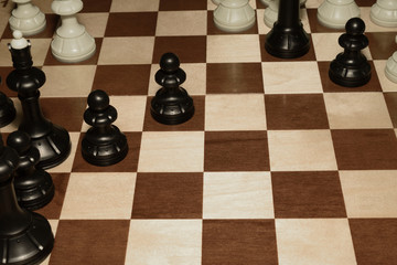 Wooden chessboard with black chessmen as a hobby concept