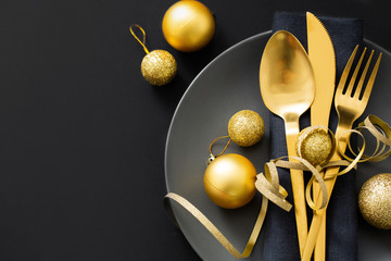 Gold cutlery served on plate for Christmas Dinner