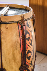 Vertical view of Bombo Leguero and sticks.  Argentinian percussion instrument, made with wood and...