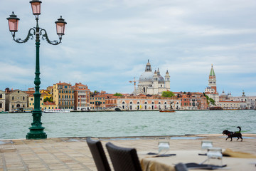 Cafe on the banks of the Venetian lagoon of the island on San Giorgio Maggiore, Piazza San Marco and the Doge's Palace. Venice