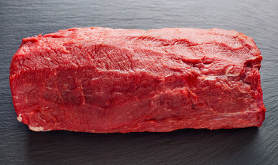 piece of fresh beef meat on slate